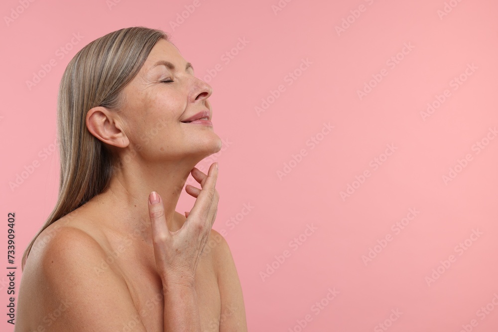 Beautiful woman with healthy skin on pink background, space for text Beautiful woman with healthy skin on pink background, space for text