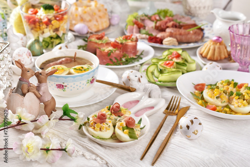 Easter table with traditional white borscht, deviled eggs, salads and pastries © teressa