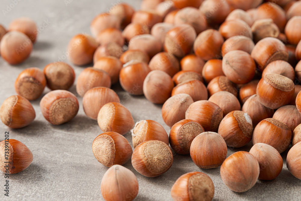 A large group of shelled hazelnuts on the table. Low angle view. A large group of shelled hazelnuts on the table. Low angle view.