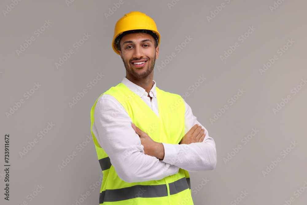 Engineer in hard hat on grey background Engineer in hard hat on grey background