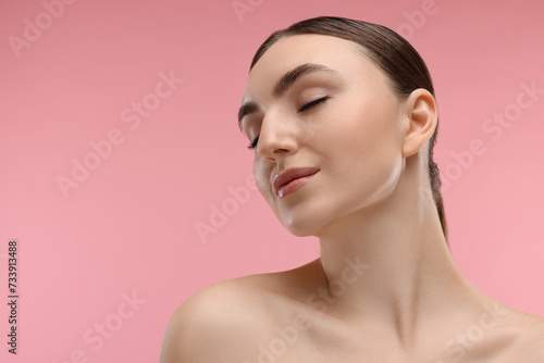 Portrait of beautiful woman on pink background. Space for text
