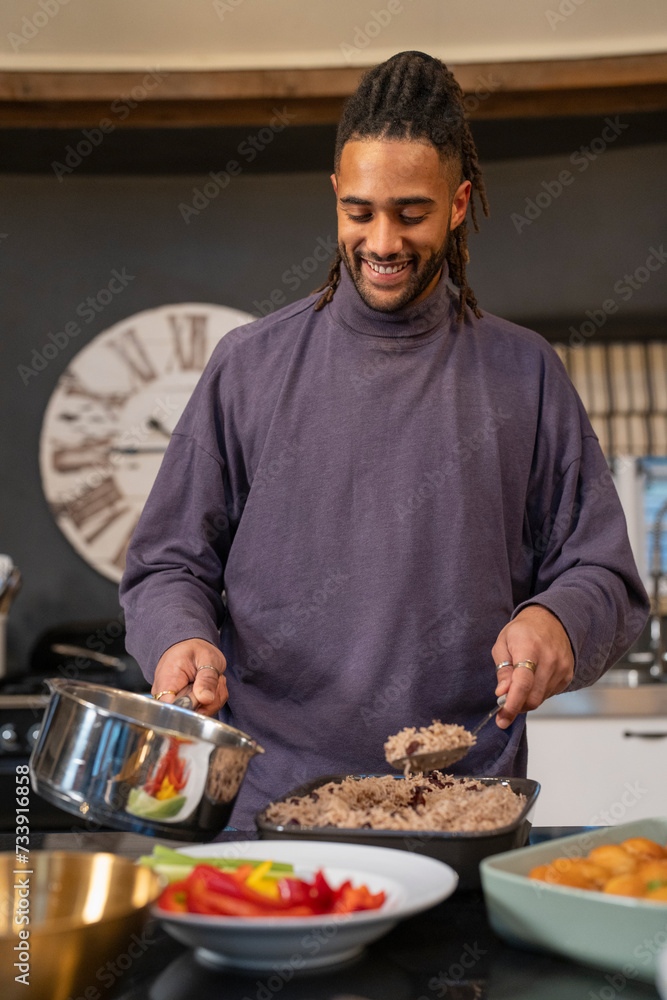 Smiling man preparing food in kitchen 
