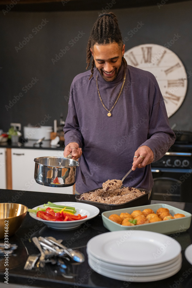 Smiling man preparing food in kitchen Smiling man preparing food in kitchen