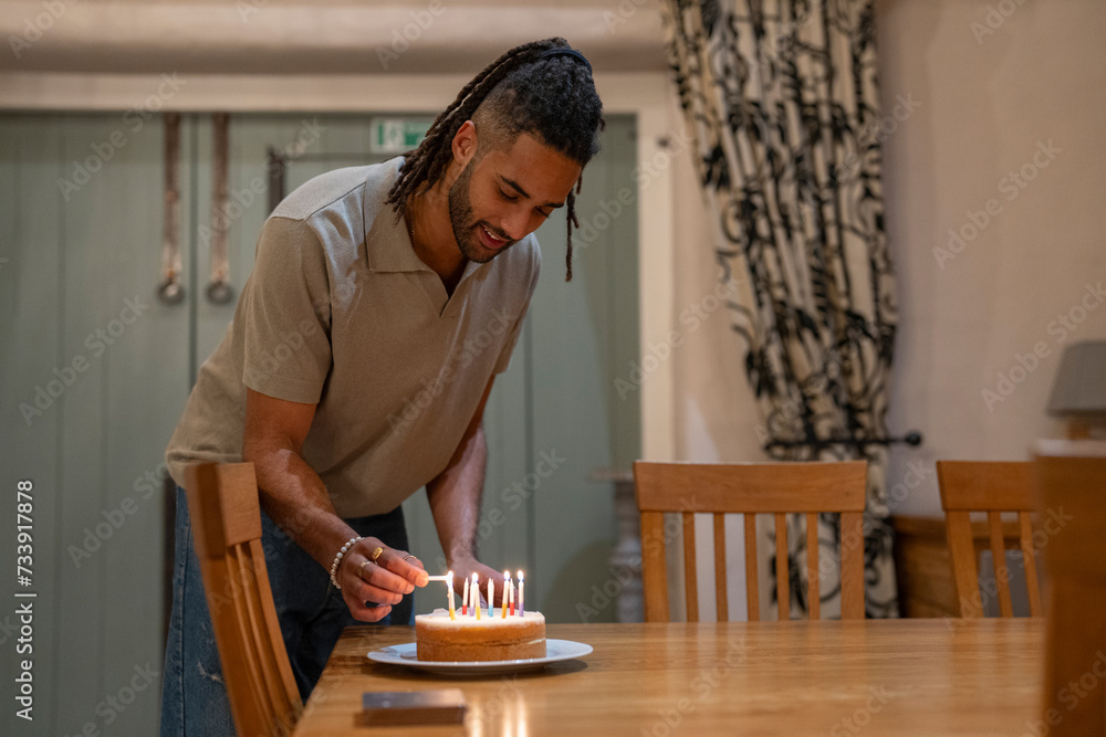 Man lighting candles on birthday cake Man lighting candles on birthday cake