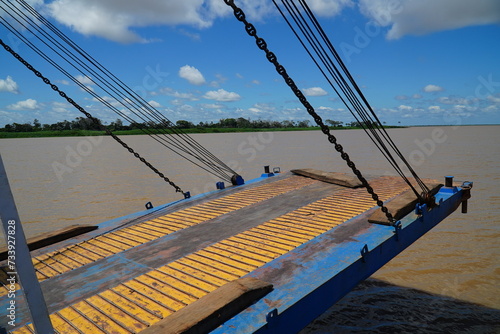 Front loading flap with support ropes of a steel ferry and a cargo ship traveling up and down the Amazon River in Brazil. Juriti, Para state, Brazil. photo