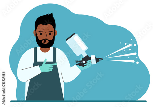 A man in a special suit holds a paint spray gun.