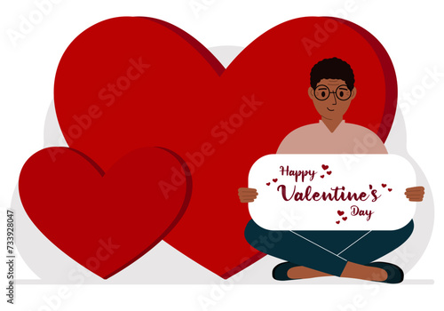 A man holds a Happy Valentine's Day greeting against a background of red hearts.