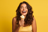 Young pretty brunette girl over isolated colorful background with a cornet ice cream