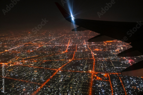 View of the night city through an airplane window