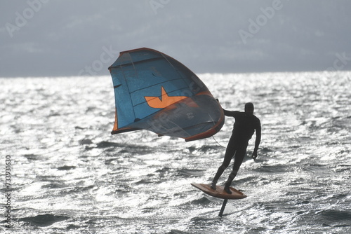 a man riding a kite board on top of a large body of water