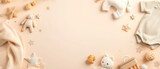 Baby items and toys on a pastel brown background.