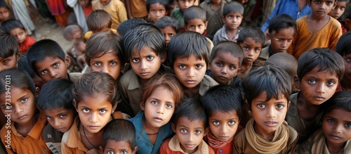 Image of impoverished children gazing at the camera with solemn expressions. photo