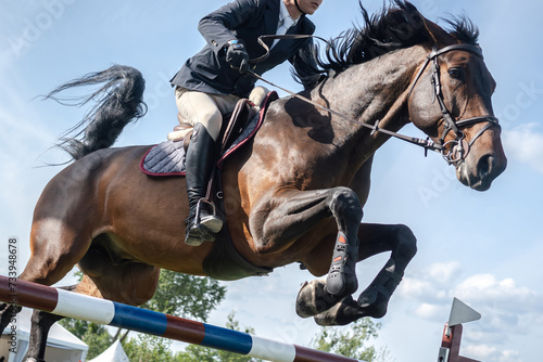Equestrian Sports photo-themed: Horse jumping, Show Jumping, Horse riding. Jockey competing in horse jumping competition.