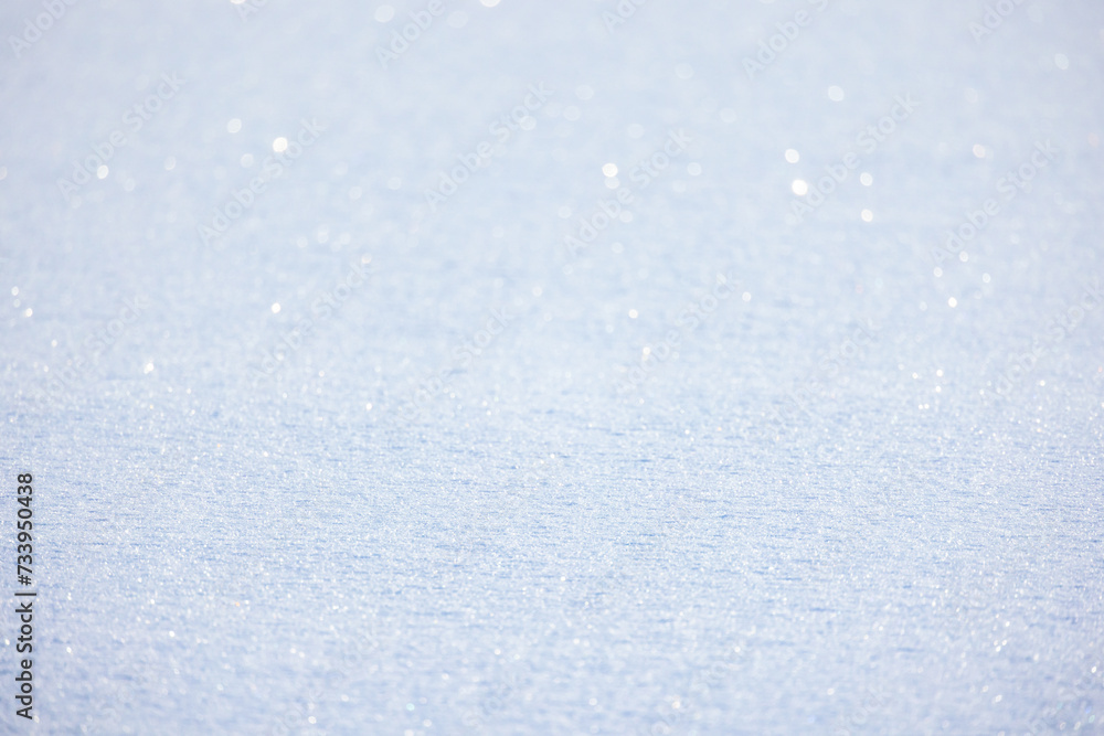Obraz premium Shiny snowdrift surface on a sunny winter day, natural background