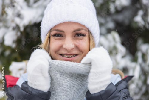 Woman With Braces Wearing White Hat and Gloves at the Park