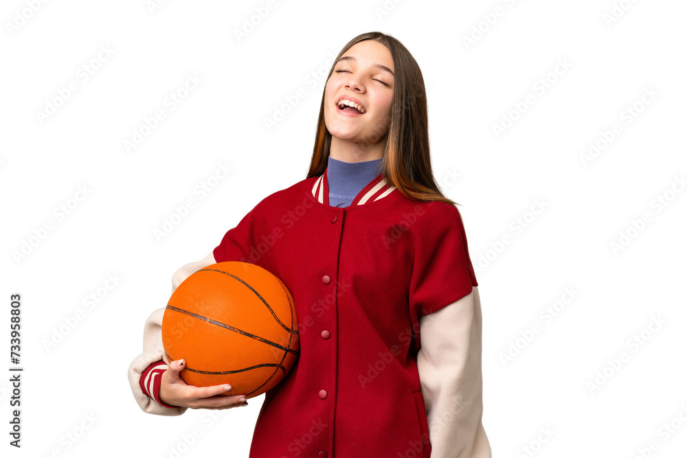 Teenager girl playing basketball over isolated chroma key background laughing