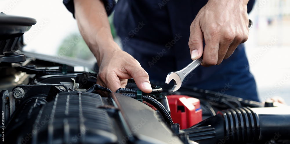Mechanic are using the wrench to repair and maintenance auto engine at car repair shop,Car auto services and maintenance check concept. Mechanic are using the wrench to repair and maintenance auto engine at car repair shop,Car auto services and maintenance check concept.