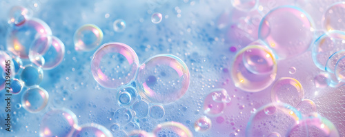 Macro photo of bubbles in water. Pink and blue background with foam made of soap, shampoo, lotion, detergent. Colorful banner with copy space for laundry and cleaning services beauty skin care concept