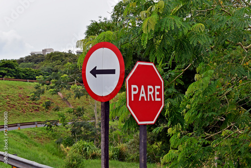 Traffic sign indicating one way adn STOP (pare) in Ribeirao Preto, Sao Paulo, Brazil