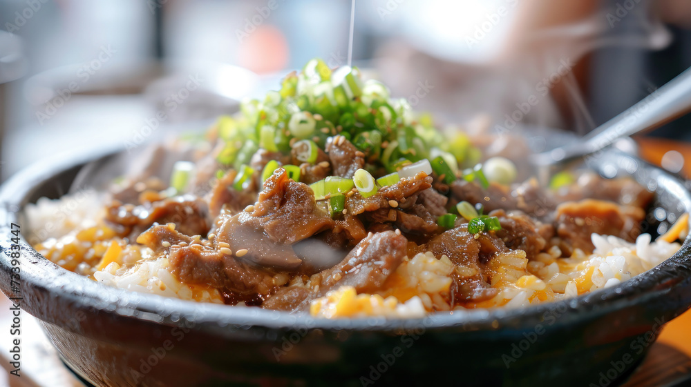 Korean Bulgogi Pork Rice on top with onsen york with someone put spoon in, hot steaming looking moist and very delicious Korean Bulgogi Pork Rice on top with onsen york with someone put spoon in, hot steaming looking moist and very delicious