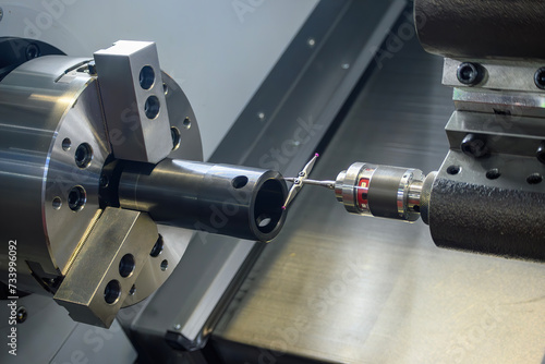The modular touch probe checking the tube parts on CNC lathe machine. photo