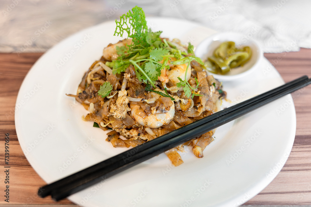 Close-up of Hokkien mee, a typical Malaysian dish with strong influences of Indonesian, Chinese, and Indian flavors Close-up of Hokkien mee, a typical Malaysian dish with strong influences of Indonesian, Chinese, and Indian flavors
