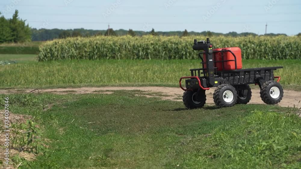 A transport agrodron helps in working on a farmer's field. Ground drone, transport version. A transport agrodron helps in working on a farmer's field. Ground drone, transport version.