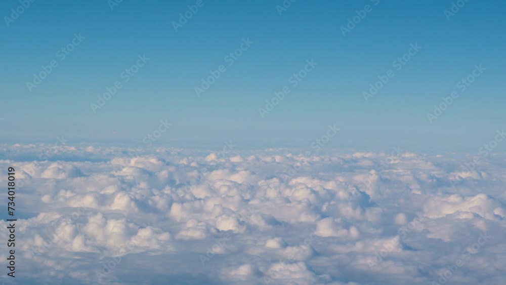 Clouds and sky as seen through window of an aircraft, aerial view Clouds and sky as seen through window of an aircraft, aerial view