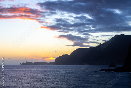 Dawn on Ilhéu da Pocariça cliffs from the distance - Madeira, Portugal  © piszczke