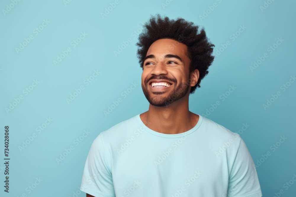 Handsome african american man in casual t-shirt on blue background Handsome african american man in casual t-shirt on blue background