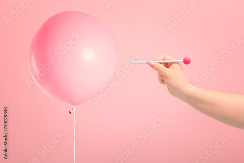 Hand blowing a baloon