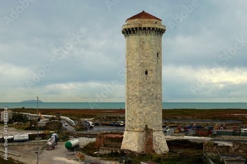 Picturesque landscape view of medieval Marzocco Tower in Livorno, Italy. Ancient watchtower, built in 15th century. Inside the port area in the north of the city. Travel and tourism concept