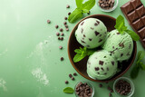 Bowl of mint chocolate chip ice cream with mint leaves