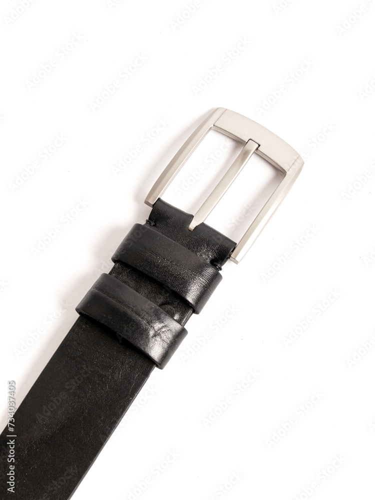 Genuine leather belt on white background. Massive metal buckle Genuine leather belt on white background. Massive metal buckle