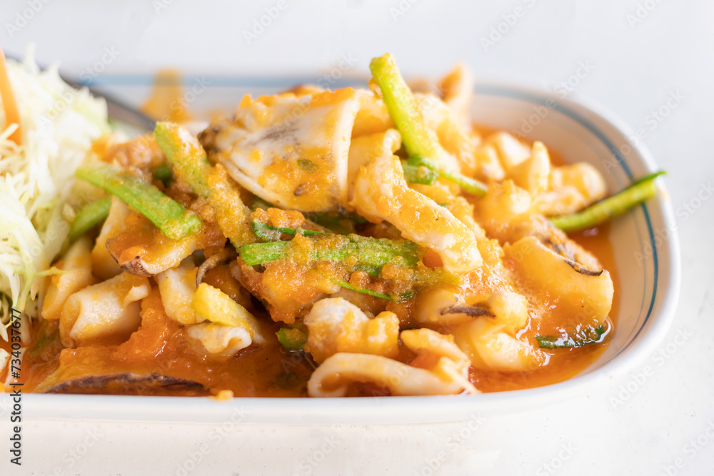 Stir fried squid with salted egg york. Delicious Thai dish. Stir fried squid with salted egg york. Delicious Thai dish.