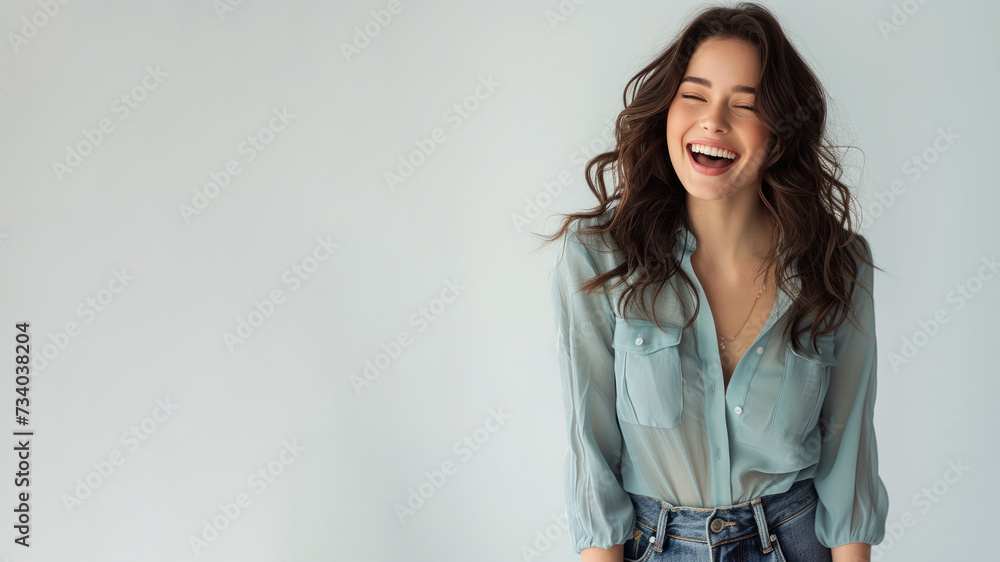 Brunette woman wear blue shirt smiling laugh out loud isolated on grey Brunette woman wear blue shirt smiling laugh out loud isolated on grey
