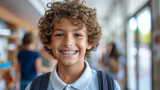 Closeup portrait of smiling smart curly haired school boy wearing braces on teeth looking at camera Education concept