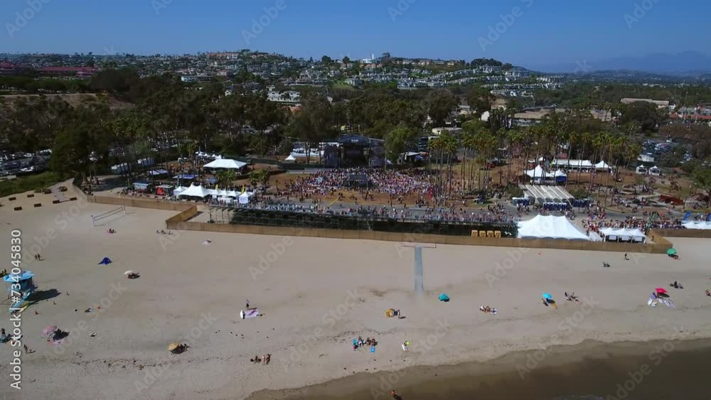 Aerial Panning Shot Of People At Musical Concert At Beach On Sunny Day - Dana Point, California Aerial Panning Shot Of People At Musical Concert At Beach On Sunny Day - Dana Point, California