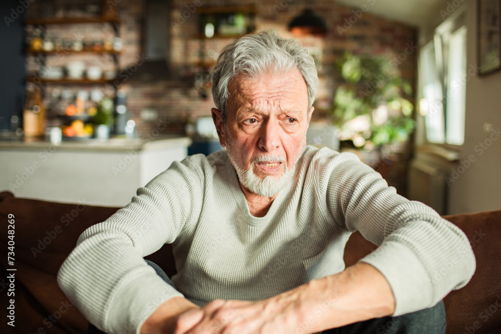 Worried Senior Man Sitting on Sofa at Home Worried Senior Man Sitting on Sofa at Home