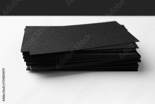 Blank black business cards on white background, closeup