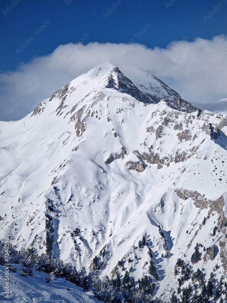Obraz premium Winter rocky mountain peak covered with snow, beautiful aerial view