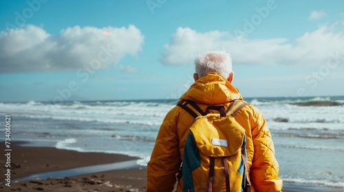 Elderly Man Gazing into the Horizon on a Coastal Trek, Embarking on a Journey of Solitude and Reflection. Senior Traveler in Nature, Embracing the Adventure of Life