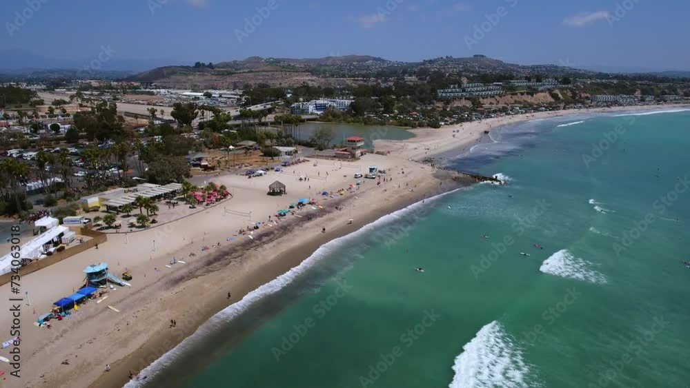 Aerial Shot Of Male And Female At Beach During Sunny Day, Drone Flying Forward Over Sea Waves - Dana Point, California Aerial Shot Of Male And Female At Beach During Sunny Day, Drone Flying Forward Over Sea Waves - Dana Point, California