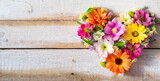Bouquet of beautiful flowers in heart shape on background of rustic wooden planks. Celebrations concept