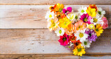 Bouquet of beautiful flowers in heart shape on background of rustic wooden planks. Celebrations concept