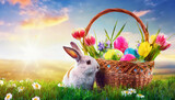 Easter bunny in sunny garden with colorful eggs and spring flowers in the basket. Copy space for text. Celebration concept