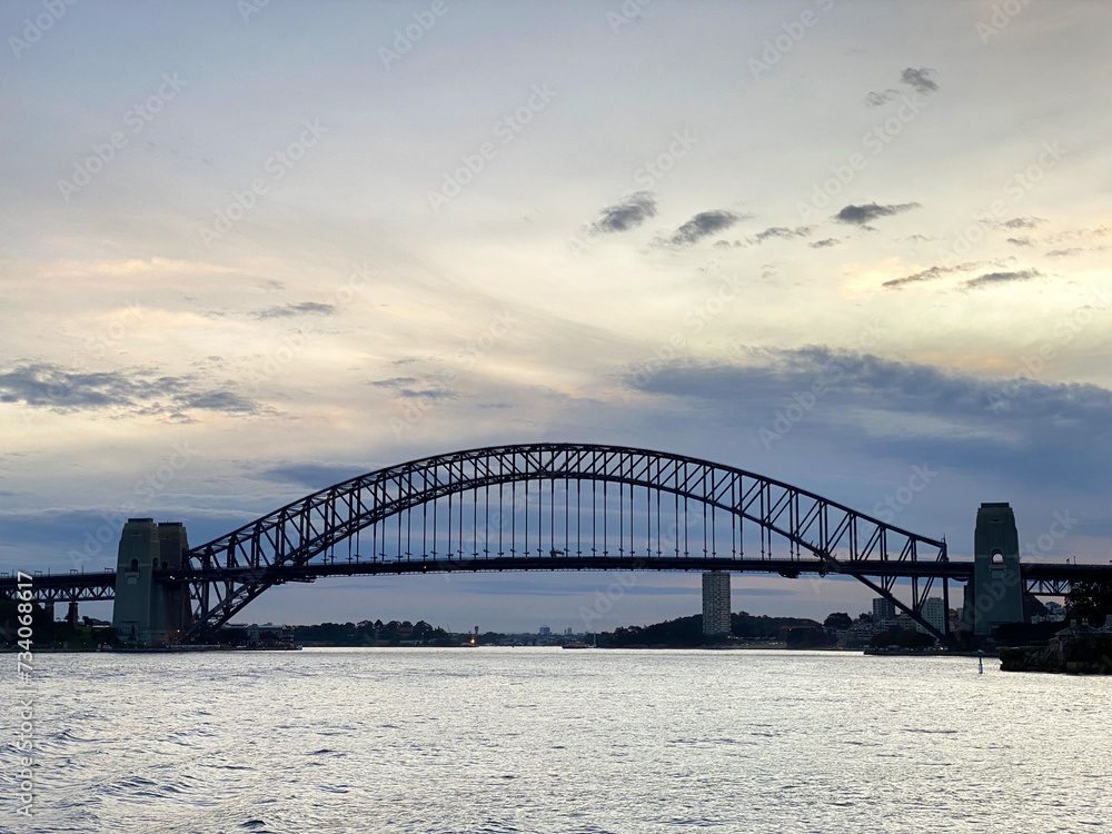 Sydney Harbour bridge at night. City harbour bridge silhouette at sunset. Largest steel arch bridge from the ocean at nightfall, Australia.
