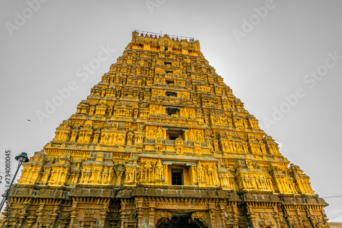 Entrance tower ( Gopuram) of Varadharaja Perumal Temple and Lord Atthi Varadar Perumal god statue inside the pond, Kanchipuram, Tamil Nadu, South India - Religion and Worship scenario image photo