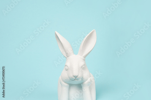 blue Easter background with white bunny, copy space . Easter greeting card © Nastya