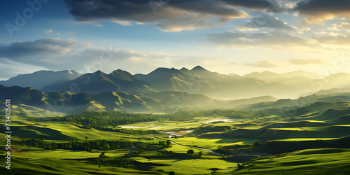 Panoramic landscape of green grassy meadows at sunset. © Graphicsstudio 5